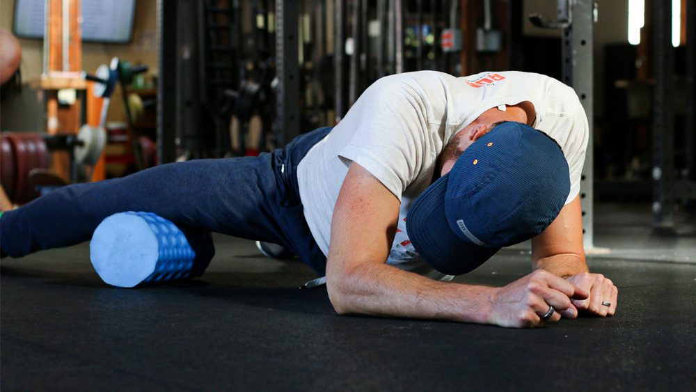 Coach Nate foam rolling the quads.